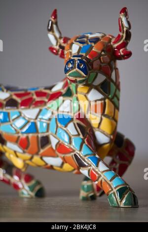 Miniature multicolored statue of bull in Gaudi style, traditional souvenir from Barcelona, not art object, only inexpensive spanish gift Stock Photo