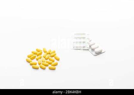Packing oval yellow pills, tablets, pastils. Isolated on a white Stock Photo