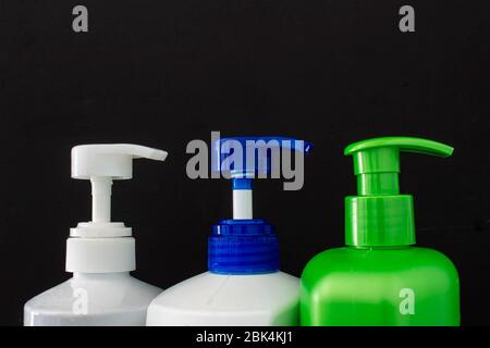 Shampoo colorful bottles top on a black background Stock Photo