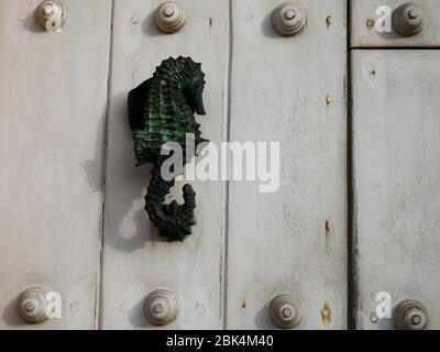 Cartagena, Colombia, August 1 2019: Doorknoker with a seahorse over a white door in old town Cartagena Stock Photo