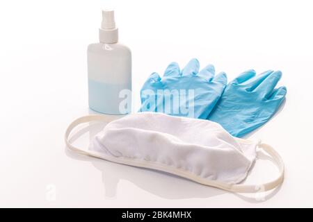 Set of protecting disposable ntiviral various filtering safety face masks, gloves, sanitizer for hands on white background. Stock Photo