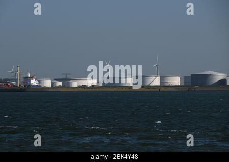 Oil storage tanks and wind turbines are seen at Rotterdam port on April 21, 2020 in Rotterdam, Netherlands. Credit: Yuriko Nakao/AFLO/Alamy Live News Stock Photo