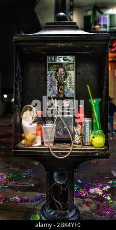 For a drunken night out, a telephone booth is good for calling a cab... or to deposit your drinks... Mardis Gras on Bourbon Street in the French Qtr Stock Photo