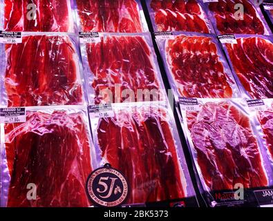 Famous Iberico meat products produced from black Iberian pigs in La Boqueria Market next to La Rambla. Barcelona, Catalonia, Spain. Stock Photo