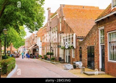 Veere, Netherlands - June 09, 2019: historic buildings in Veere, with unidentified people. Veere is famous for its picturesque old town and a popular Stock Photo