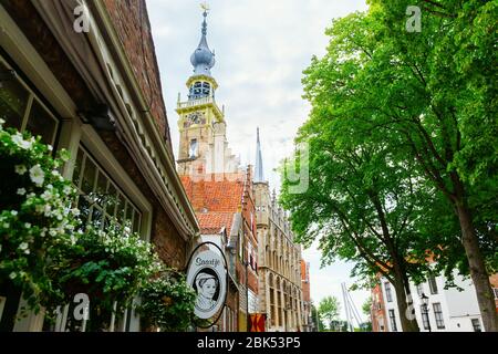 Veere, Netherlands - June 09, 2019: historic buildings in Veere, with unidentified people. Veere is famous for its picturesque old town and a popular Stock Photo