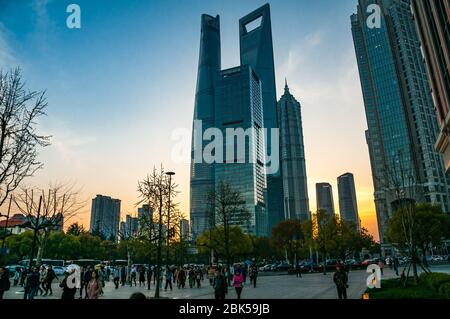The Shanghai Tower, Jinmao Tower and Shanghai World Financial Center skyscrapers seen at sunset from around Dongchang Road subway station. Stock Photo