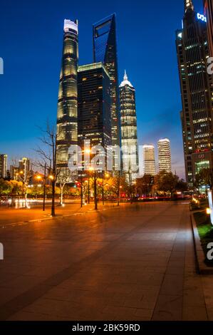The Shanghai Tower, Jinmao Tower and Shanghai World Financial Center skyscrapers seen at during the blue hour (evening) from around Dongchang Road sub