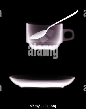 Teacup saucer and teaspoon, X-ray. Stock Photo