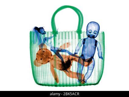 Woven bag with dolls and stuffed animal, coloured X-ray. Stock Photo