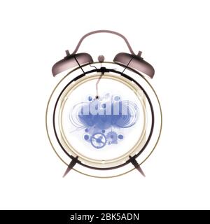 Alarm clock, coloured X-ray. Stock Photo