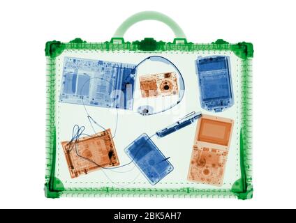 Briefcase and IT accessories, coloured X-ray. Stock Photo