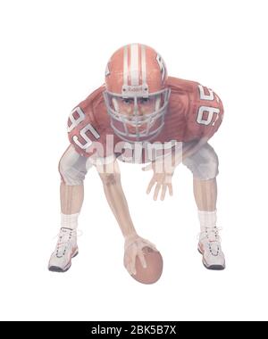 American football player skeleton, coloured X-ray. Stock Photo