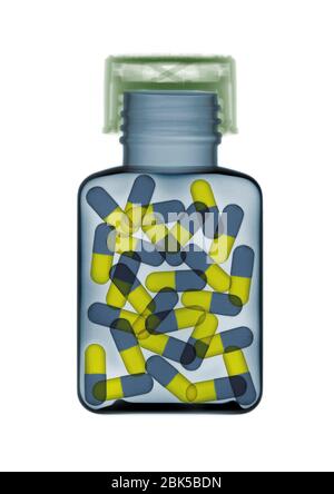 Blue and yellow pills in a bottle, coloured X-ray. Stock Photo