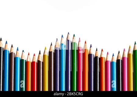Multi colour pencils arranged on a white background. Copy space Stock Photo