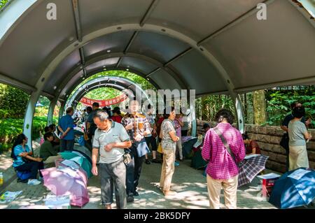 Parents try to find matches for their unmarried adult children at the marriage market in the park at People’s Square in Shanghai. Stock Photo