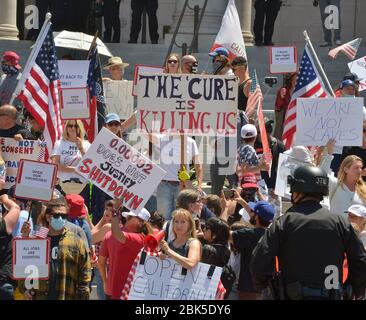 Los Angeles, USA. 1st May 2020. Police officers prevent protesters from confronting one another near City Hall, some to decry the stay-at-home orders from the city and state while others counter-protested against those who did not want to follow.the COVID-19 guidelines in Los Angeles on Friday, May 1, 2020. While some states are planning to allow businesses to reopen and make.public spaces accessible, Gov. Gavin Newsom and Los Angeles Mayor Eric Garcetti have not given specific timelines as to when they will relax their emergency orders. Credit: UPI/Alamy Live News Stock Photo