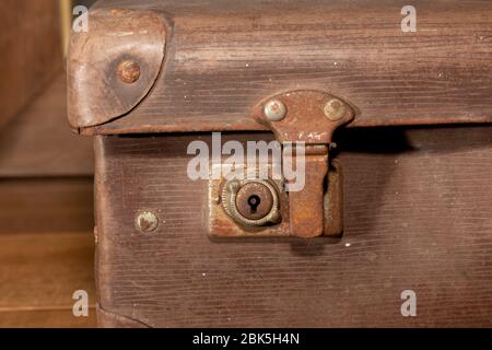 A rusty lock on an old brown leather suitcase Stock Photo