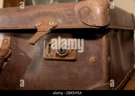 A rusty lock on an old brown leather suitcase Stock Photo