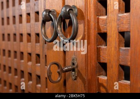 An antique key in an old wooden cupboard Stock Photo