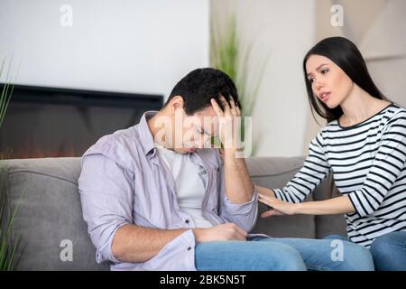 Unhappy guy bowed his head with his eyes closed. Stock Photo