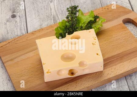 Maasdam cheese brick with thyme branch Stock Photo