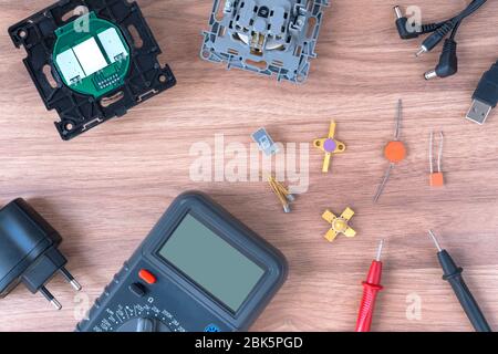 Multimeter and power supply cables. conducting tests and electrical measurements. electronics repair.  Stock Photo