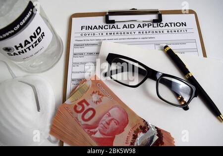 Illustrative concept image for Covid-19 (Coronavirus) pandemic. Mock-up of financial aid application for Canadian people during global economic crisis Stock Photo