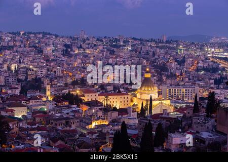 Biblical city of Nazareth and Basilica of the Annunciation at dusk, Israel Stock Photo