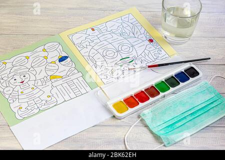 Handmade crafts. Creative activities for children on vacation and in quarantine. Coloring book with english words. Mask for protection against the vir Stock Photo