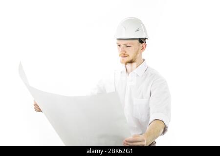 Satisfied handsome engineer in safety helmet working with blueprint documents Stock Photo