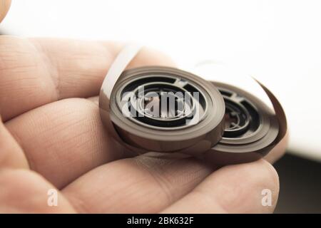 Disassembled audio cassette. Tangled cassette tape in knots. Old musical equipment. Stock Photo