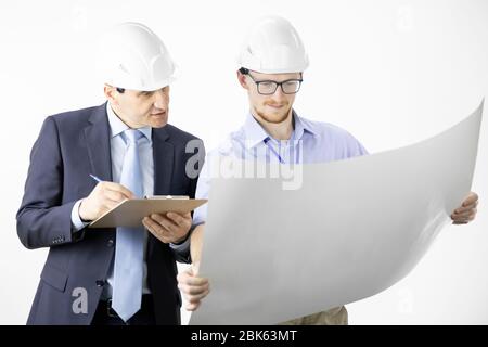 Architectural engineers working with blueprint documents marking edits Stock Photo