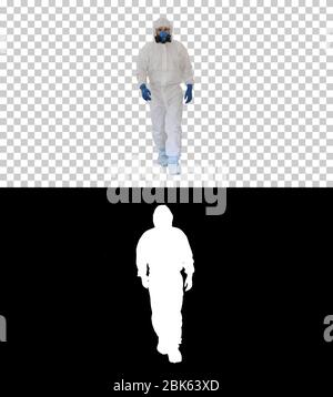 Man wearing hazmat suit walking, Alpha Channel Stock Photo