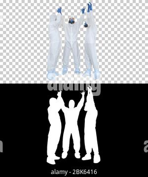 Doctors in hazamat suits stacking hands Team work, Alpha Channel Stock Photo