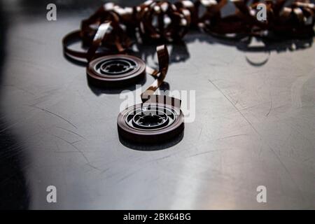 Disassembled audio cassette. Tangled cassette tape in knots. Old musical equipment. Stock Photo