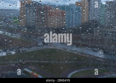 Waterdrops on a glass surface windows with cityscape background Stock Photo