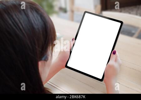 Tablet mockup in woman hands. Woman holding modern tablet with thin and round edges Stock Photo