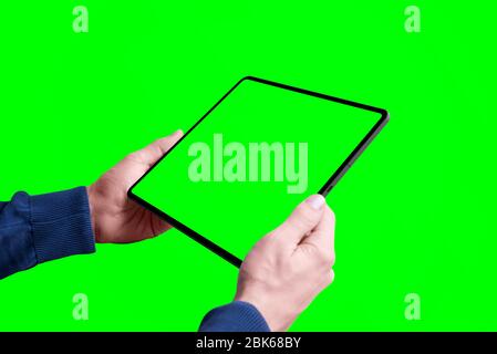 Tablet mockup in man hands isolated in chroma key green Stock Photo
