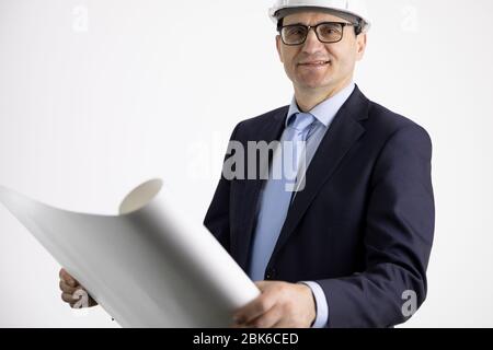 Smiling civil engineer working with documents isolated on white background Stock Photo