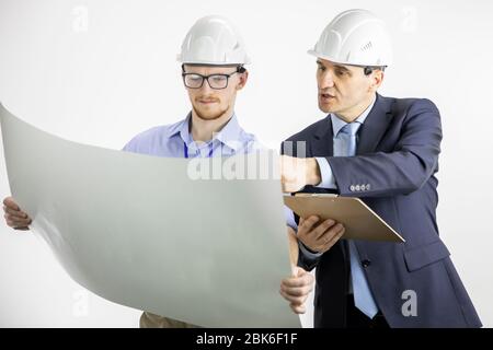 Architectural engineers working with blueprint documents on white background Stock Photo