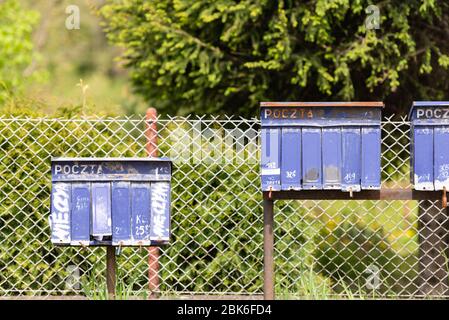 Mailboxes in Poland by the road. Village mailboxes near Cracow. Mailboxes stand in a row. Stock Photo