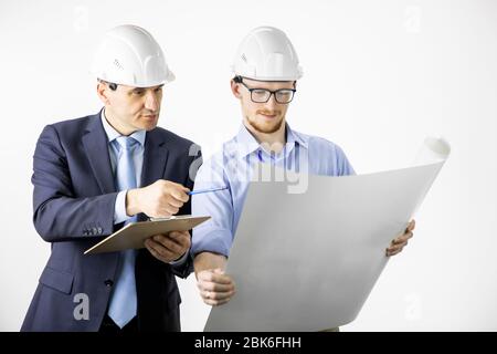 Architectural engineers working with blueprint documents discussing planing Stock Photo
