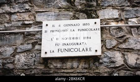 Como, Italy - November 4, 2017: marble plaque on a wall with writing in Italian - On November 11, 1894 the funicular was inaugurated - at the entrance Stock Photo