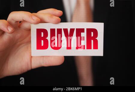Buyer word on the card shown by a man. Customer business concept Stock Photo