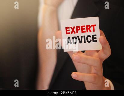 Businessman showing business card EXPERT ADVICE. Selective focus. Business consulting concept Stock Photo