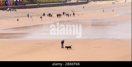 People going for a stroll and walking their dogs on the beach at Saltburn by the Sea,England,UK Stock Photo