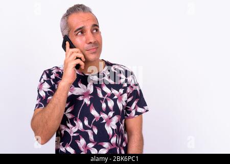 Portrait of handsome Persian tourist man talking on the phone Stock Photo