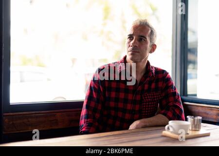 Handsome Persian man relaxing at the coffee shop Stock Photo