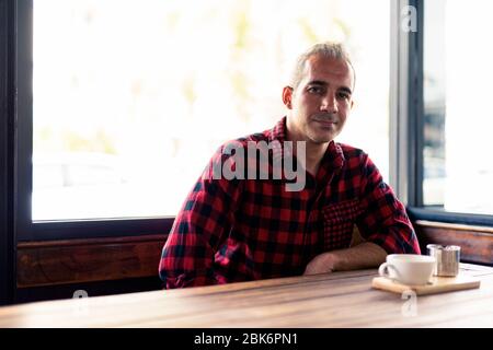 Handsome Persian man relaxing at the coffee shop Stock Photo